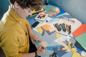 Woman in a studio office working with paper collage