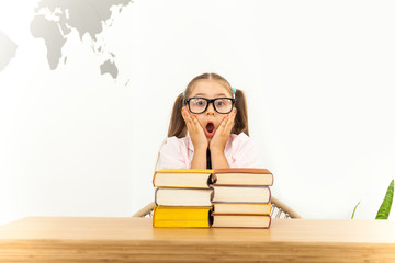 Girl studying at table on white background