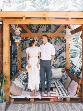 Stylish newlyweds on rustic terrace