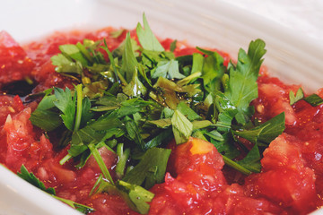 Acili ezme - turkish salad with fresh tomatos, parsley, greens, olive oil and spice. Selective focus