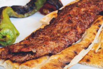 Turkish style Adana Kebab. Traditional Turkish Food Adana Kebab on Wooden Table.