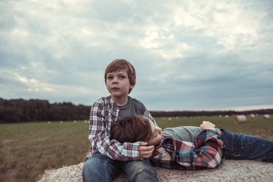 Portrait of a little boy on a haystack