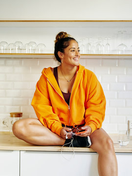 Young Woman Smiling In The Kitchen Representing A Healthy Lifestyle.