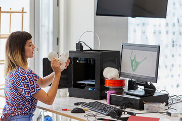 Student Examining 3D Model By Computer At Desk