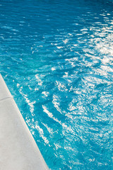 closeup of swimingpool with clean blue water summer background