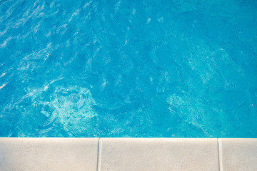 closeup of swimingpool with clean blue water summer background