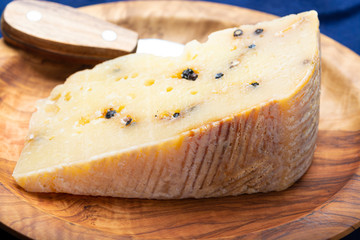 Italian aged pecorino cheese with black peppers made in region Nebrodi, Sicily, Italy