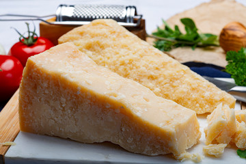 Italian original aged Parmesan cheese in two pieces close up