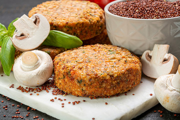 Tasty vegetarian and vegan burgers made from healthy quinoa, basil, tomatoes and champignon mushrooms