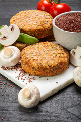 Tasty vegetarian and vegan burgers made from healthy quinoa, basil, tomatoes and champignon mushrooms