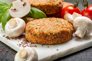 Tasty vegetarian and vegan burgers made from healthy quinoa, basil, tomatoes and champignon mushrooms