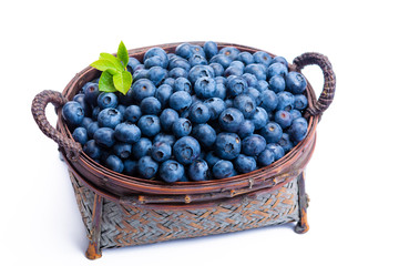 Wicker basket with blueberries, new harvest of healthy berries, isolated on white backgroud