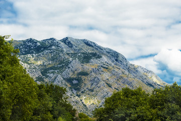 Naklejka premium Beautiful mountain landscape on sunny summer day. Montenegro, Albania, Bosnia, Dinaric Alps Balkan Peninsula. Сan be used for postcards, banners, posters, posters, flyers, cards.