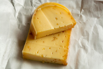 Piece of cow cheese with fenugreek seeds made in Belgian abbey by monks.