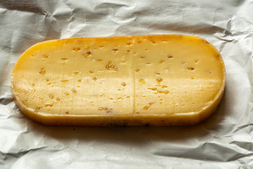 Piece of cow cheese with fenugreek seeds made in Belgian abbey by monks.