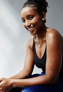 Joyful young woman smiling genuinely.