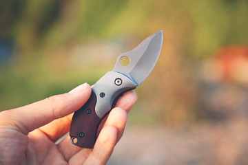 man hand pocket knife in nature