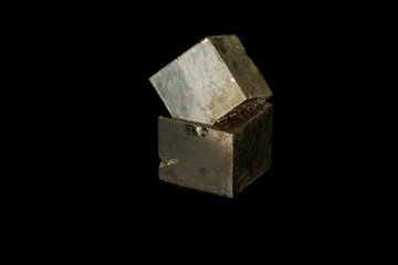 Macro mineral stone Pyrite on a black background