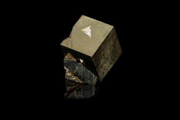 Macro mineral stone Pyrite on a black background