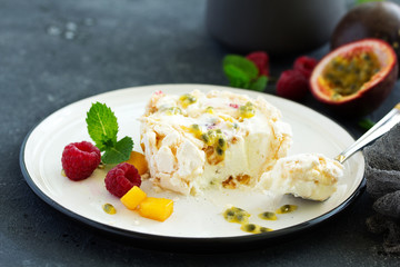 Meringue roulade with raspberries and passion fruit. Pavlova. Dessert. Selective focus