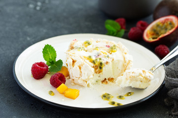 Meringue roulade with raspberries and passion fruit. Pavlova. Dessert. Selective focus