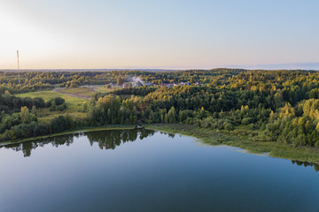 aerial view of landscape with lake at sunset