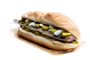 Traditional Dutch sandwich with herring and pickles isolated on white
