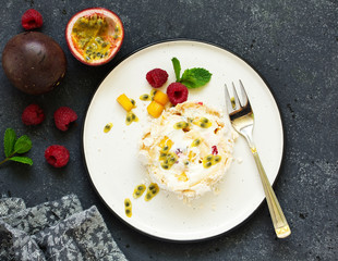 Meringue roulade with raspberries and passion fruit. Pavlova. Dessert. Selective focus