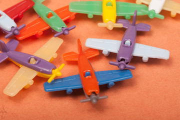 Fototapeta premium toys plastic aeroplanes on a orange background