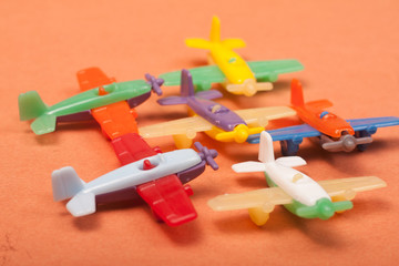 Naklejka premium toys plastic aeroplanes on a orange background