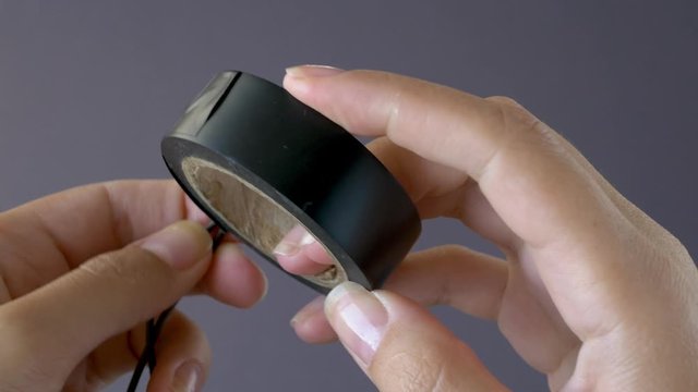 Close-up of twisted wires wrapping with electrical tape