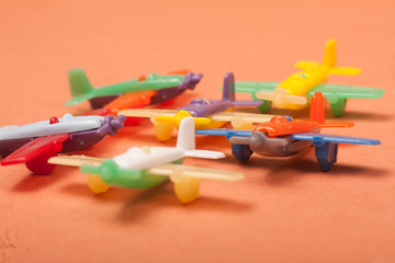 toys plastic aeroplanes on a orange background