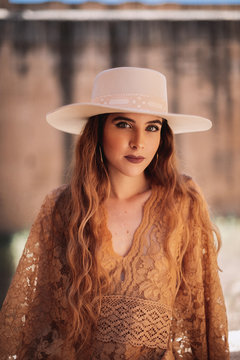 Elegant female in long dress on window