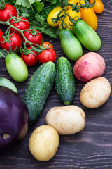 Variety of fresh raw vegetable ingredients. Autumn vegetable still life on rustic wooden background. Top view.