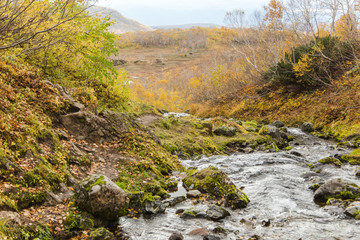 River in mountains. Beautiful autumn landscape in Kamchatka near Vachkazhetz volcano