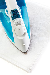 The electric iron stands on isolated white background
