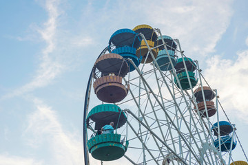Ferris wheel over blue sky. Ferris wheel in an amusement park