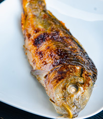 Fried fish served on the plate
