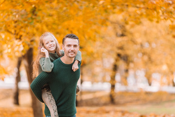 Family of dad and kid on beautiful autumn day in the park