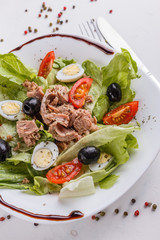 Fresh salad with iceberg lettuce,tomatoes,eggs,canned tuna and olives