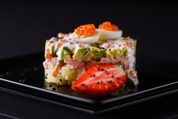 Round salad made of red fish potato and avocado