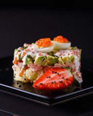 Round salad made of red fish potato and avocado