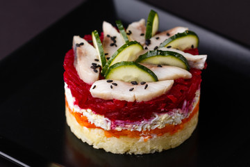 Russian salad herring under fur coat on a dark background