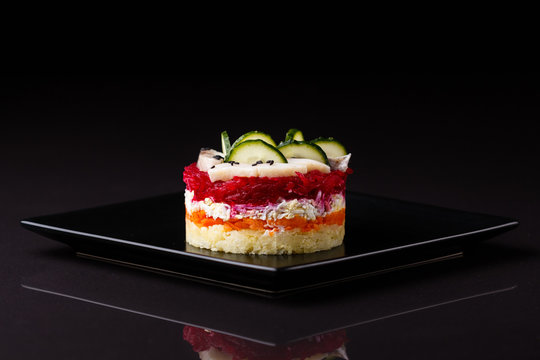 Russian salad herring under fur coat on a dark background