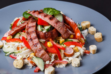 Salad with grilled sausage paprica cucumber and croutons