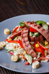 Salad with grilled sausage paprica cucumber and croutons