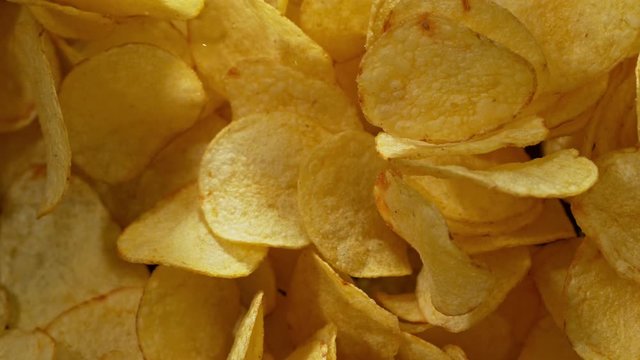 Super Slow Motion Shot of Potato Chips Flies After Being Exploded against Black Background, 1000fps. Shooted with High Speed Cinema Camera at 4K.