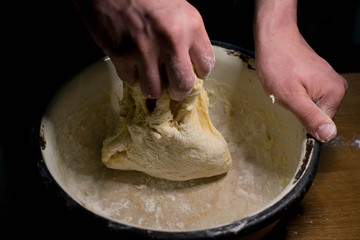 Knead the dough on a wooden table