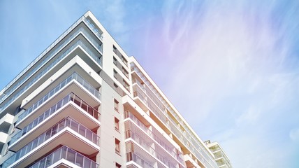 Fototapeta premium Modern apartment building detail, glass surface with sunlight