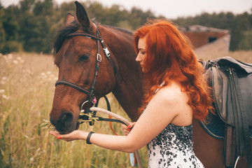 Beautiful girl with her horse walking together